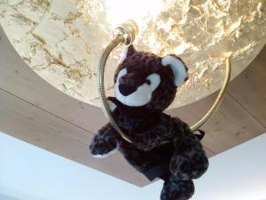 a stuffed teddy bear hanging from a wall at Hotel Vergeiner in Seefeld in Tirol