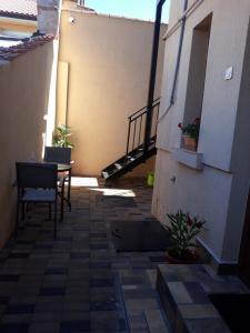 a patio with a table and a staircase in a building at Casa Dadi in Constanţa