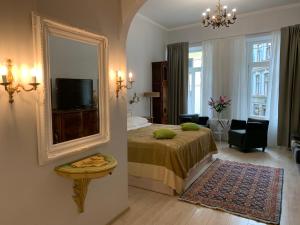 a hotel room with a bed and a mirror at NB Apartments Riga Old Town in Rīga
