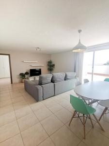een woonkamer met een bank en een tafel bij La Clavellina in Corralejo