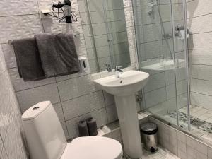 a bathroom with a toilet and a sink and a shower at NB Apartments Riga Old Town in Riga