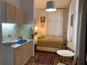 a small bedroom with a bed and a sink in it at NB Apartments Riga Old Town in Riga