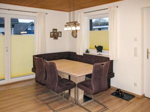 a dining room with a table and chairs at Holiday Home Heide by Interhome in Altefähr