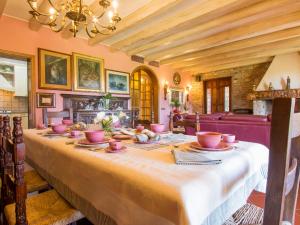 a long table with bowls and plates on it at Villa Villa Taioli by Interhome in Montecarlo