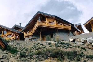 a house on top of a hill with a balcony at Alta in Valloire