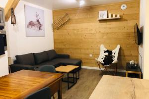 a living room with a couch and a table at Alta in Valloire
