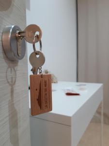 a key chain with a tag attached to a door at La Casetta sul Mare in Isola delle Femmine