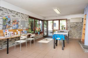 a kitchen with a table and chairs in a room at Reka-Ferienanlage Brissago in Brissago