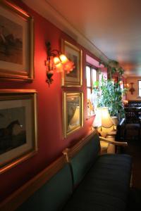 a living room with a couch and pictures on the wall at Great Danes Country Inn in Swaffham