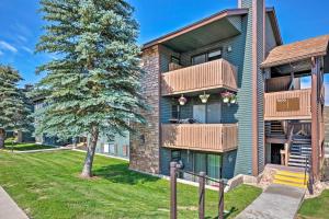a apartment building with balconies and a tree at Park City Condo with View - Walk to ShopsandDining in Park City