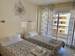 Ein Bett oder Betten in einem Zimmer der Unterkunft Neptuno Beachfront Apartments