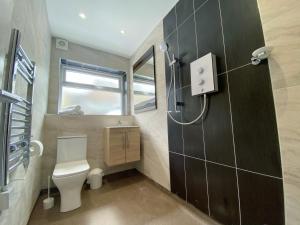 a small bathroom with a toilet and a window at Kensington Suite Sasco Apartments in Blackpool +8 photos