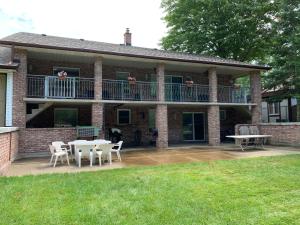 a house with a balcony and tables and chairs at Leslie in Wasaga Beach