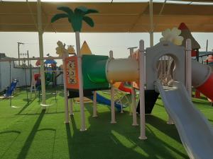 a playground with many different types of play equipment at Daraysh Hotel 
