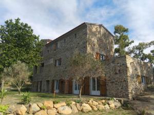 an old stone building with rocks in front of it at MULINU BIANCU in Poggio-dʼOletta