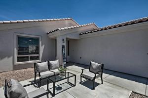 a patio with two chairs and a table in front of a house at Luxe Home with OHV Access, 5 Mi to Lake Mohave! in Bullhead City