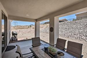 a porch with a table and chairs and a view of a beach at Luxe Home with OHV Access, 5 Mi to Lake Mohave! in Bullhead City