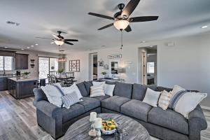 a living room with a couch and a ceiling fan at Luxe Home with OHV Access, 5 Mi to Lake Mohave! in Bullhead City