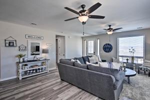 a living room with a couch and a ceiling fan at Luxe Home with OHV Access, 5 Mi to Lake Mohave! in Bullhead City
