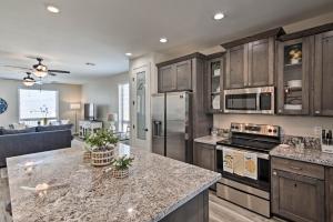 a kitchen with wooden cabinets and a counter top at Luxe Home with OHV Access, 5 Mi to Lake Mohave! in Bullhead City