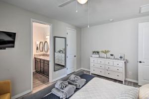 a bedroom with a large mirror and a sink at Luxe Home with OHV Access, 5 Mi to Lake Mohave! in Bullhead City