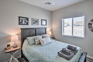 a bedroom with a bed and a desk and a window at Luxe Home with OHV Access, 5 Mi to Lake Mohave! in Bullhead City