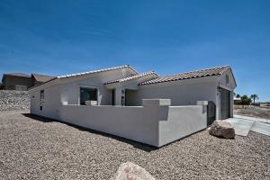 a white house with a lot of gravel at Luxe Home with OHV Access, 5 Mi to Lake Mohave! in Bullhead City