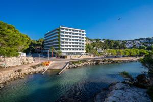 a building next to a river with a building at ARTIEM Audax - Adults Only in Cala Galdana
