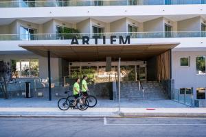 two people riding bikes in front of a building at ARTIEM Audax - Adults Only in Cala Galdana