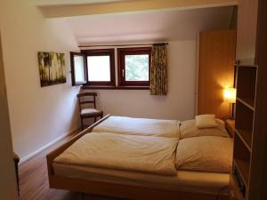 a bedroom with a large bed and a window at Ferienwohnung Bachforelle in Neuenkirchen