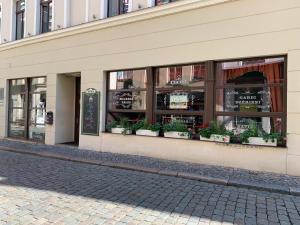 a store front with potted plants in the windows at NB Apartments Riga Old Town in Rīga