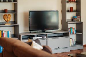 a living room with a tv and a couch at FeWoLa in Wieda