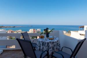 パレオコラにあるPanoramio Paleochora Apartmentsの海の景色を望むバルコニー(テーブル付)
