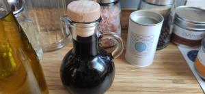 a bottle of oil sitting on a table with other items at Ferienwohnung Belchenblick in Staufen im Breisgau +26 photos