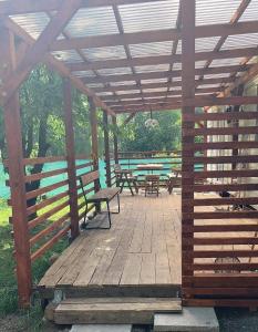 a wooden pergola with benches and picnic tables at Mobilheim Loučná nad Desnou in Loučná nad Desnou