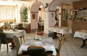 a restaurant with tables and chairs in a room at Hotel Ebner in Bad Königshofen im Grabfeld