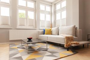 a living room with a couch and a table at OSTKÜSTE - Kaiser Karl Design Apartments in Heringsdorf