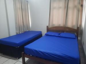 En eller flere senger på et rom på Apartamento Guarapari
