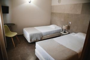 Кровать или кровати в номере Hotel Laitau