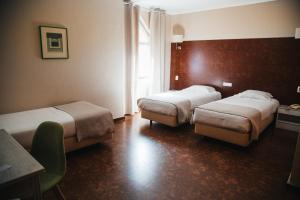 Кровать или кровати в номере Hotel Laitau +20 фотографий
