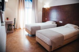 Кровать или кровати в номере Hotel Laitau