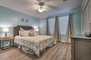 a bedroom with a bed and a ceiling fan at Gulfport Bungalow by Jones Park and Beach Access! in Gulfport