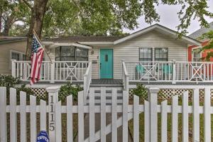 a white picket fence in front of a house at Gulfport Bungalow by Jones Park and Beach Access! in Gulfport