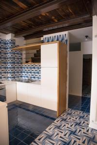 a kitchen with blue and white tiles on the floor at Blu Marina in Vietri