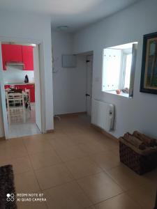 a room with a living room and a kitchen with red cabinets at lugar del pazo nª9-albeos in Albeos +27 photos