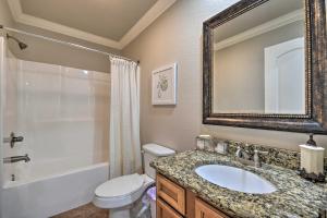 a bathroom with a sink and a toilet and a mirror at Waterfront Lake Hamilton Getaway with Boat Ramp! in Hot Springs +31 photos