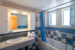 a bathroom with a sink, toilet and tub at Kalimera Mare in Kardamaina