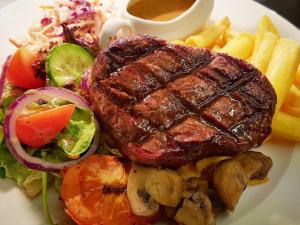 a plate of food with a steak and a salad at The Dog & Crook in Romsey