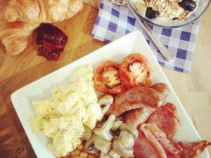 a plate of breakfast food on a wooden table at The Dog & Crook in Romsey