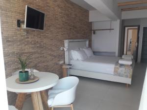 Posteľ alebo postele v izbe v ubytovaní Notus Suites